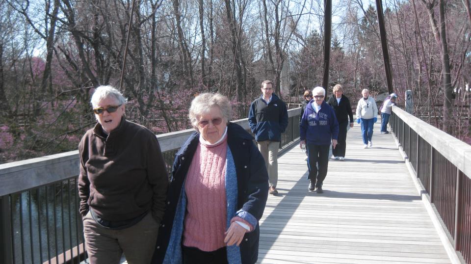 seniors walking over bridge