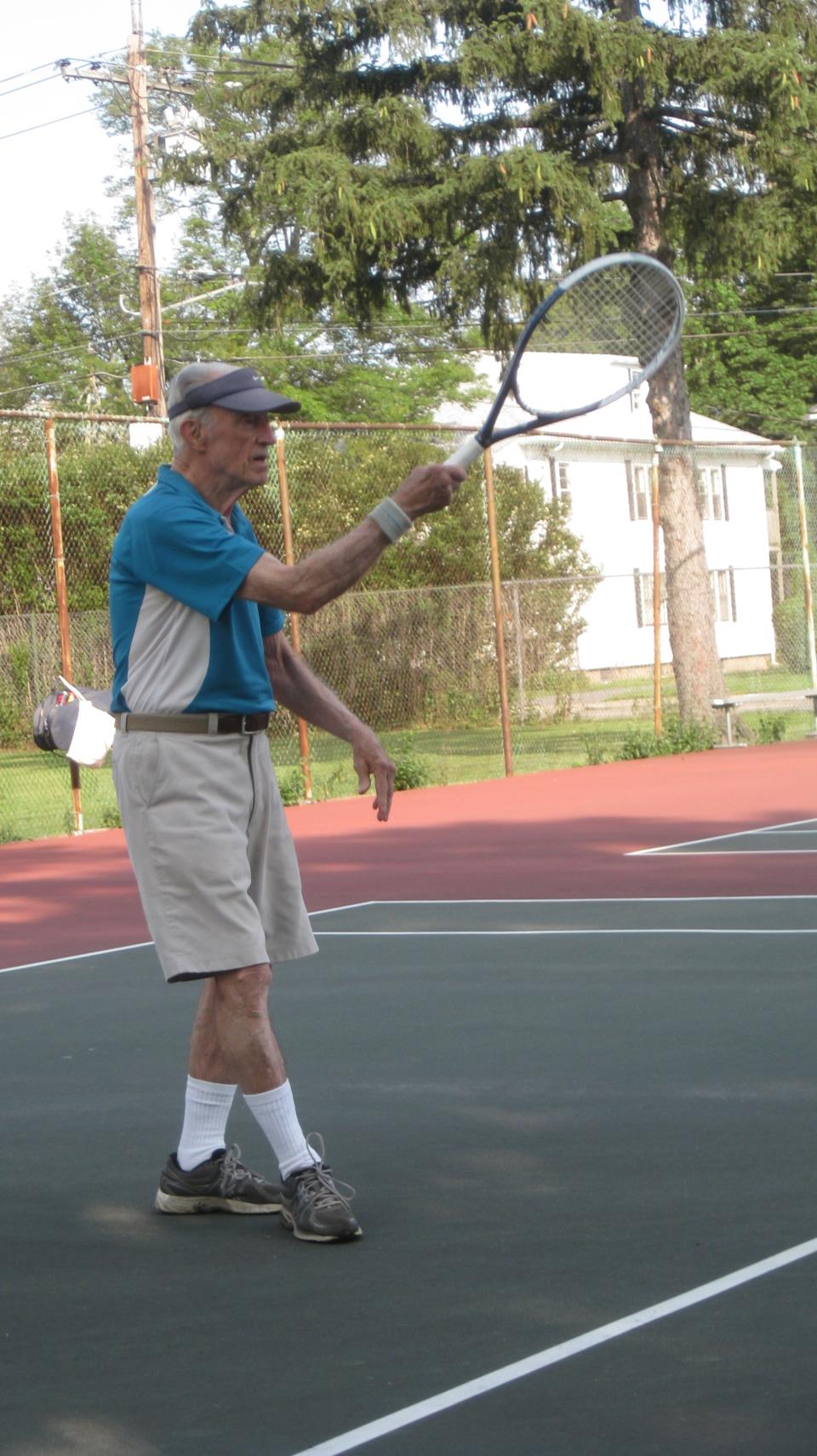 senior playing tennis