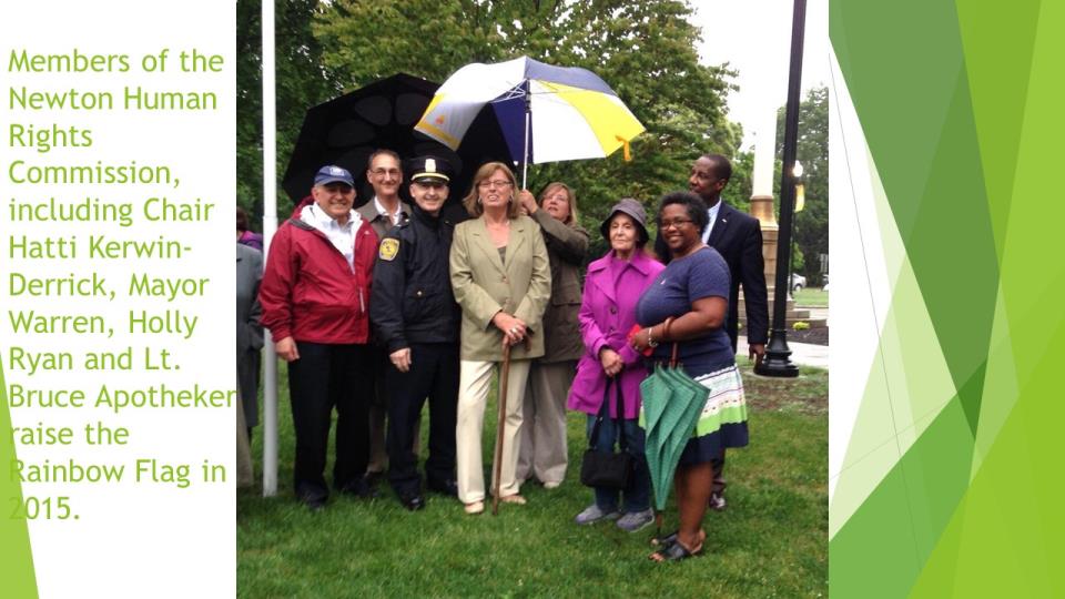 Newton Humans Rights Commission members araising the rainbow flag, 2015